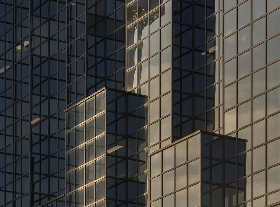 Glass office towers reflecting the sky